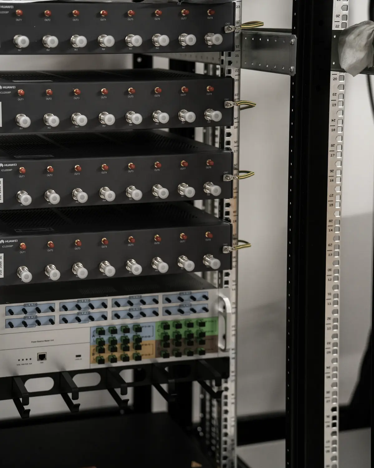 A rack of network and server equipment, lit from one side.